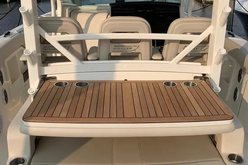 Slide: The Image of 2019 Boston Whaler 380 Outrage boat deck with seating and cup holders. - 21