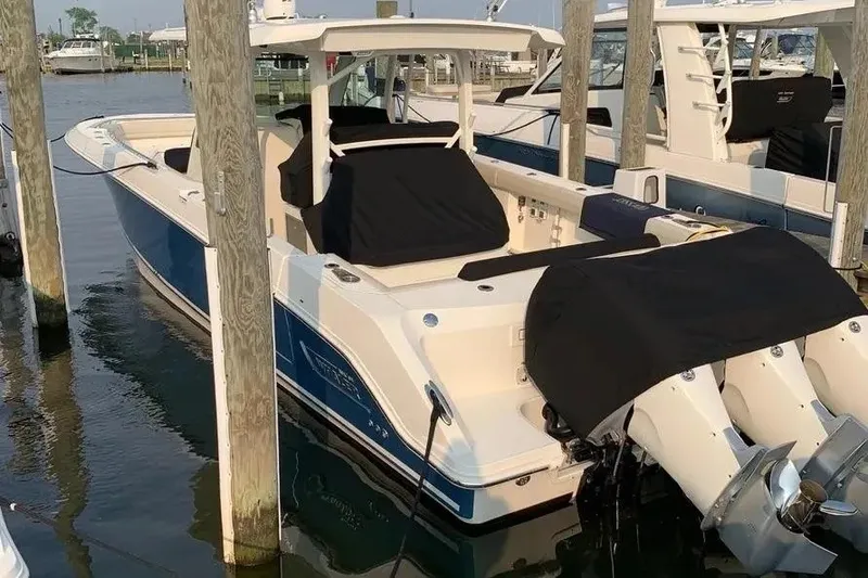 Slide: The Image of 2019 Boston Whaler 380 Outrage docked, featuring dual engines and sleek design. - 35