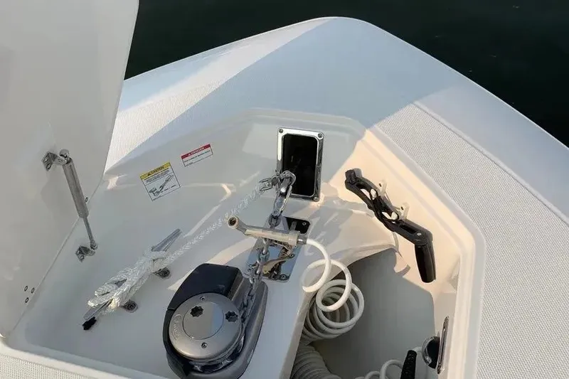 Slide: The Image of 2019 Boston Whaler 380 Outrage anchor compartment with winch and rope storage. - 43