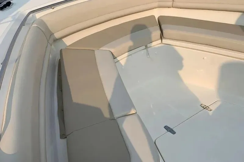 Slide: The Image of 2019 Boston Whaler 380 Outrage boat interior with cushioned seating area. - 7