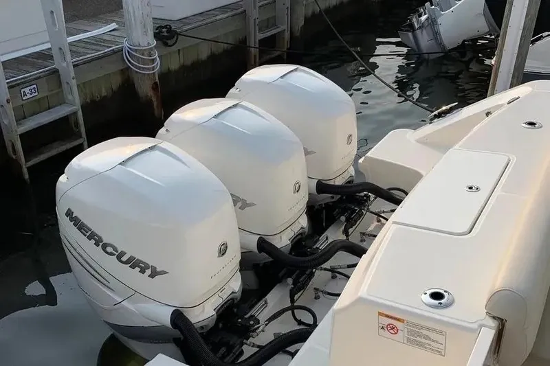 Slide: The Image of 2019 Boston Whaler 380 Outrage with triple Mercury outboard engines at dock. - 10