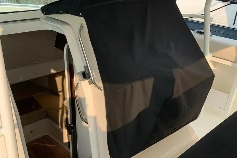 Slide: The Image of 2019 Boston Whaler 380 Outrage cabin entrance with black cover. - 49
