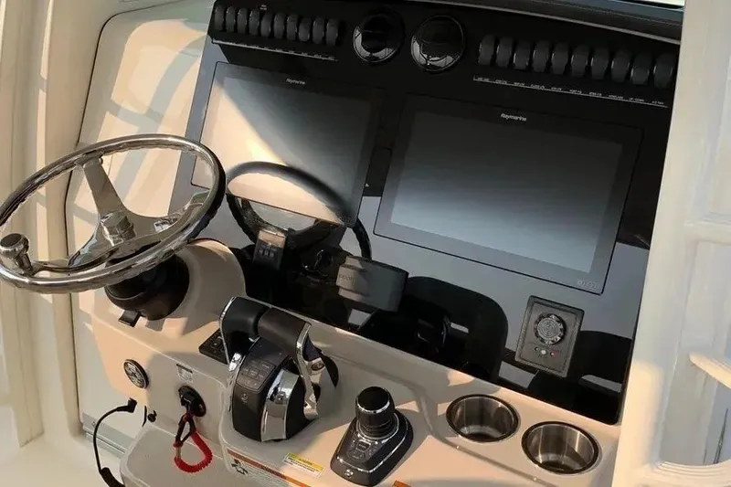 Slide: The Image of Control panel of 2019 Boston Whaler 380 Outrage with steering wheel and navigation screens. - 46