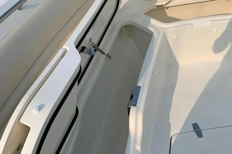 Slide: The Image of 2019 Boston Whaler 380 Outrage interior storage compartment with beige seating. - 36