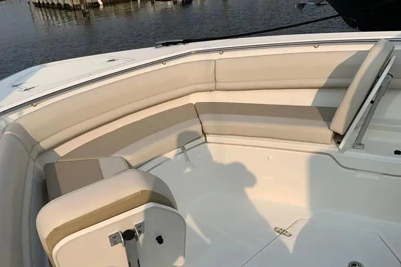 Slide: The Image of 2019 Boston Whaler 380 Outrage boat interior with cushioned seating area. - 9