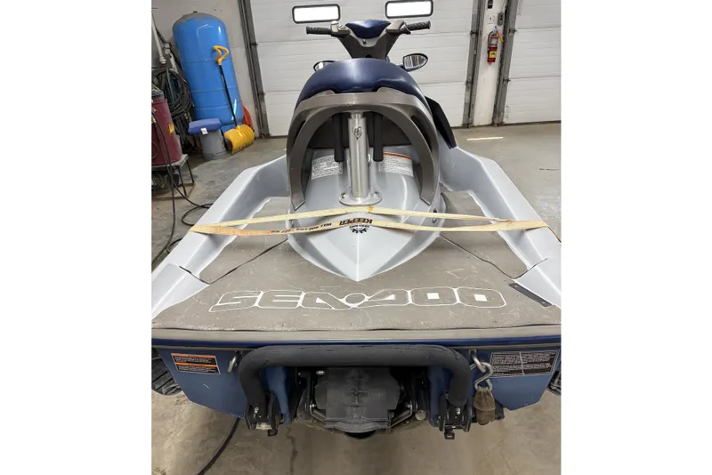 Slide: The Image of 2004 Sea-Doo GTX 4-TEC Supercharged jet ski in a garage setting. - 4