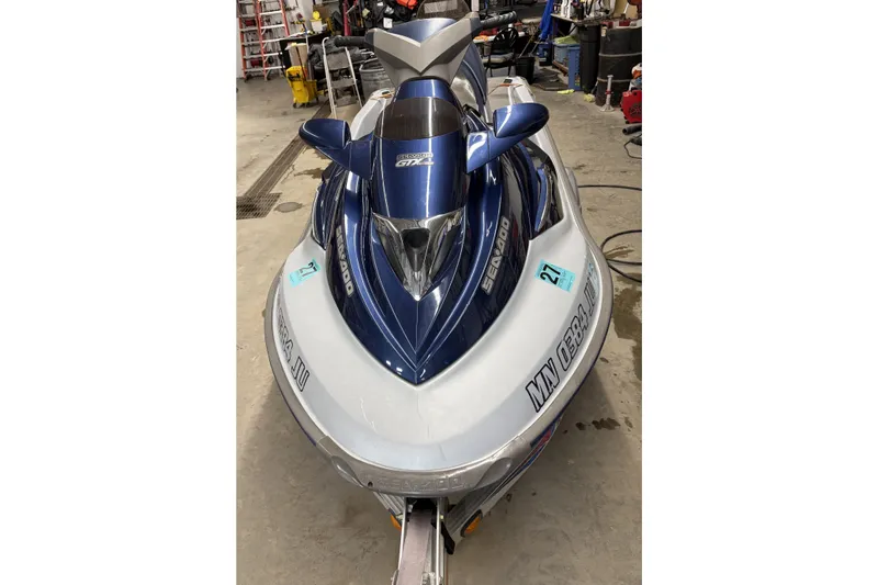Slide: The Image of 2004 Sea-Doo GTX 4-TEC Supercharged jet ski in a garage setting. - 2