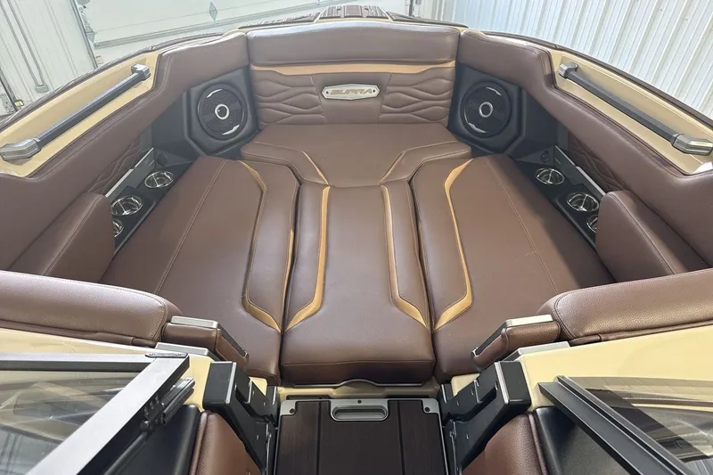 Slide: The Image of Luxurious interior of 2027 Supra SL 550 boat with brown leather seating and speakers. - 47
