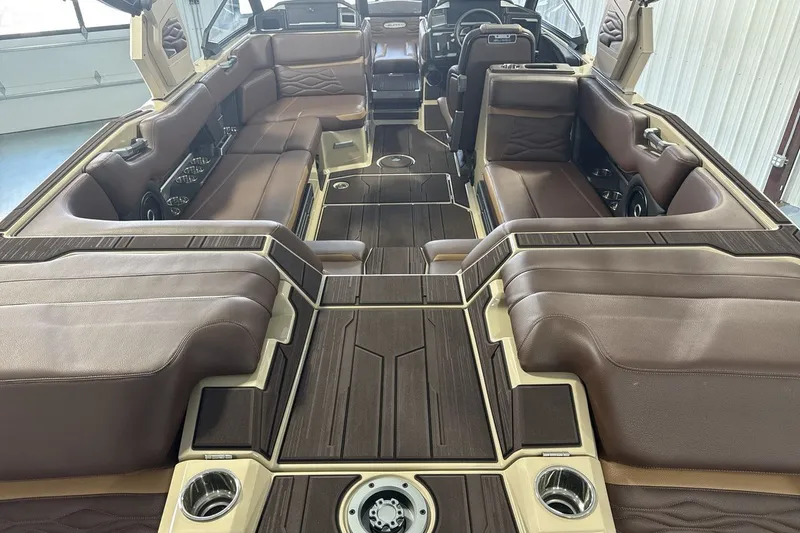 Slide: The Image of Luxurious interior of 2027 Supra SL 550 boat with brown leather seating and wood accents. - 45