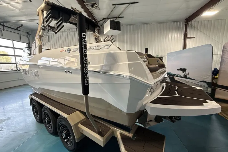 Slide: The Image of 2027 Supra SL 550 boat on trailer in indoor showroom. - 39