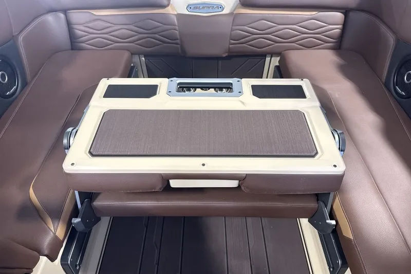 Slide: The Image of 2027 Supra SL 550 interior with brown leather seating and a foldable table. - 59