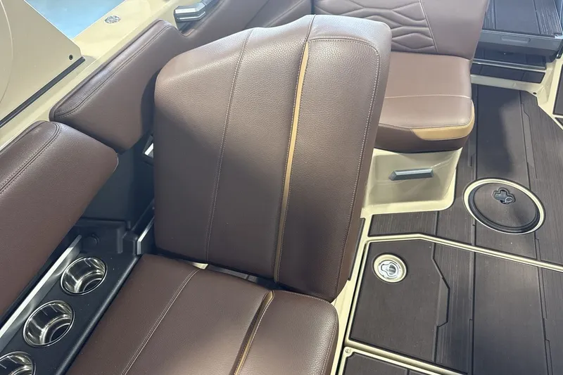 Slide: The Image of Luxurious brown leather interior of 2027 Supra SL 550 boat with cup holders. - 61