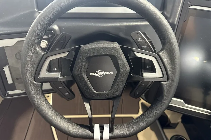 Slide: The Image of Steering wheel of a 2027 Supra SL 550 with integrated controls and modern design. - 50