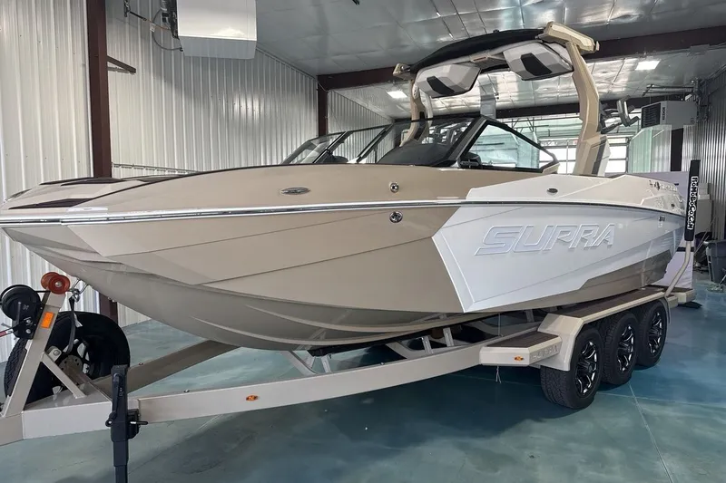 Slide: The Image of 2027 Supra SL 550 boat on trailer in indoor storage facility. - 37