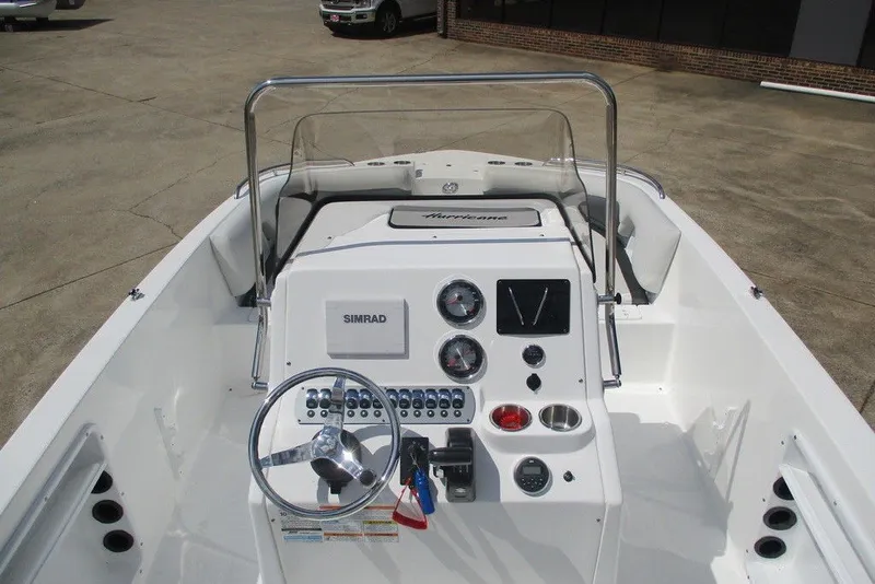 Slide: The Image of 2019 Hurricane SunDeck Sport CC 231 OB boat dashboard with steering wheel and controls. - 7
