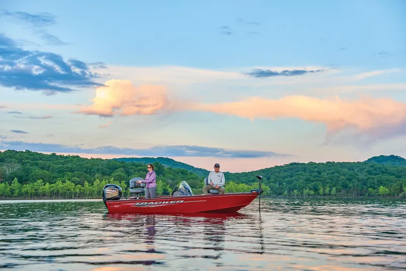Slide: The Image of Manufacturer Provided Image: 2026 Tracker Super Guide V-16 SC boat on a serene lake at sunset. - 47