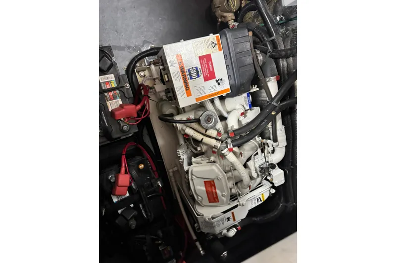 Slide: The Image of Engine compartment of a 1994 Sea Ray 300 Sundancer with visible wiring and components. - 20