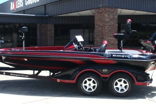 The Image of 2008 Ranger Z19 Comanche boat with dual axle trailer parked outside a building. - 0