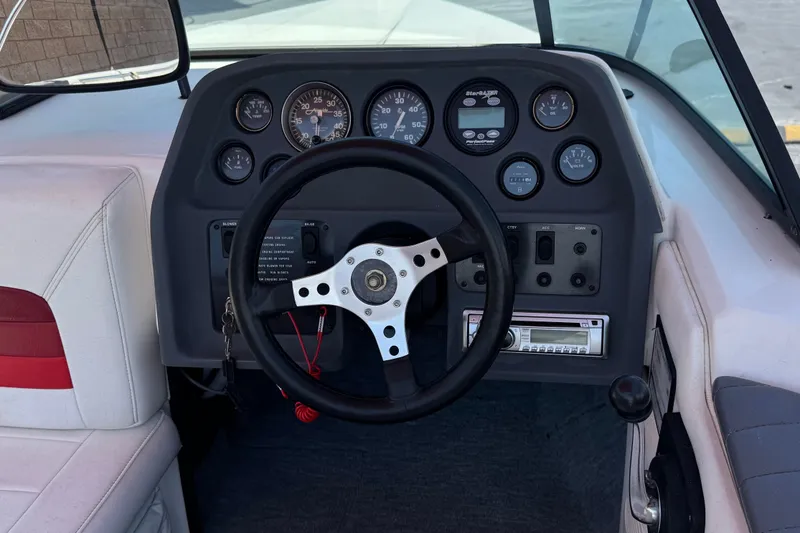 Slide: The Image of 1991 Ski Supreme MS Tournament Series boat dashboard with steering wheel and gauges. - 17