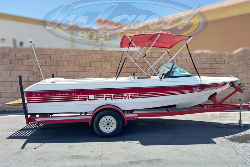 The Image of 1991 Ski Supreme MS Tournament Series boat with red accents on a trailer. - 0