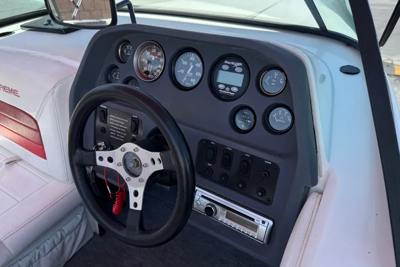 Slide: The Image of Dashboard of a 1991 Ski Supreme MS Tournament Series boat with gauges and steering wheel. - 18