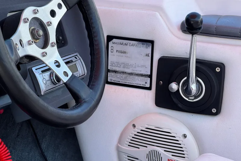 Slide: The Image of 1991 Ski Supreme MS Tournament Series boat dashboard with steering wheel and control lever. - 19