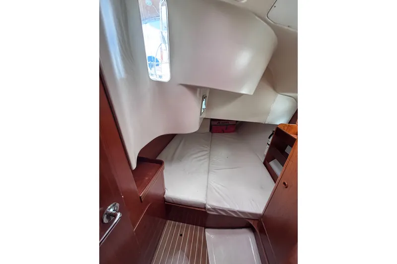 Slide: The Image of Interior cabin of 1993 Beneteau Oceanis 400 sailboat, featuring cozy sleeping area. - 26