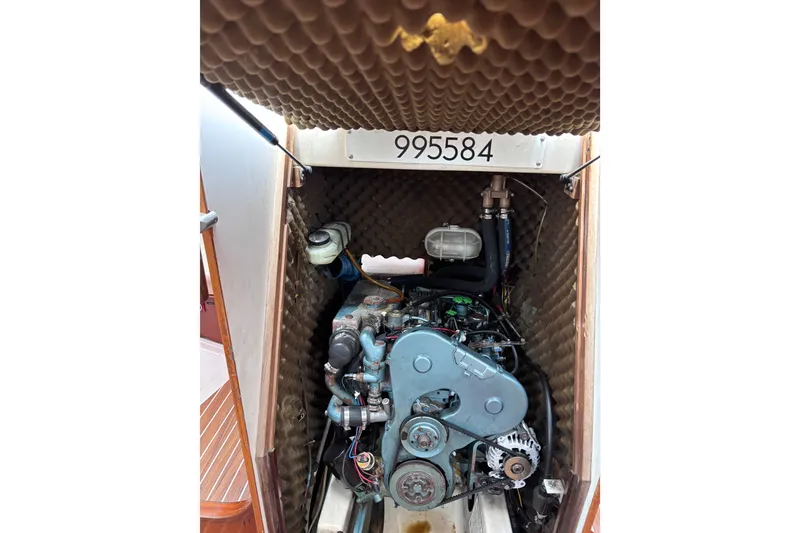 Slide: The Image of Engine compartment of a 1993 Beneteau Oceanis 400 sailboat, showcasing mechanical components. - 32
