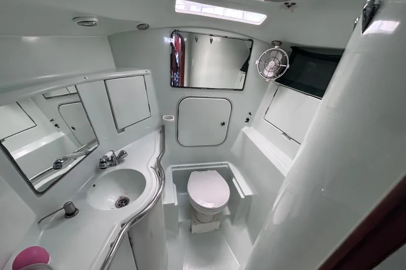 Slide: The Image of Bathroom interior of 1993 Beneteau Oceanis 400 yacht, featuring sink, toilet, and mirror. - 36