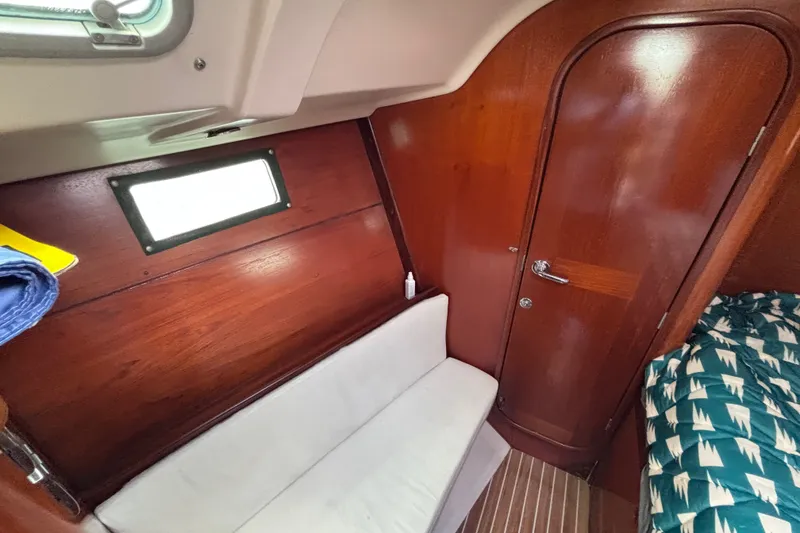 Slide: The Image of Interior of 1993 Beneteau Oceanis 400 sailboat with wooden paneling and cozy seating. - 35