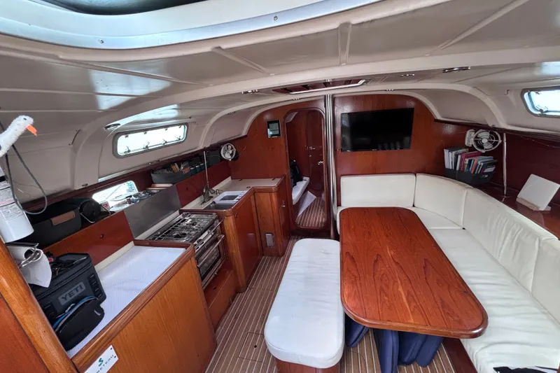Slide: The Image of Interior of 1993 Beneteau Oceanis 400 yacht with cozy seating and kitchen area. - 30