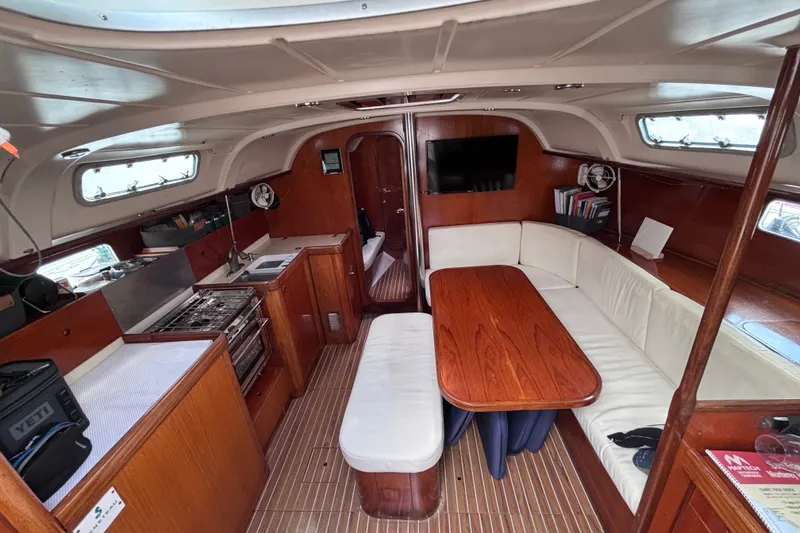 Slide: The Image of Interior of 1993 Beneteau Oceanis 400 yacht with kitchen and seating area. - 29