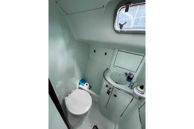 Slide: The Image of Bathroom interior of 1993 Beneteau Oceanis 400 yacht, featuring toilet and sink. - 33