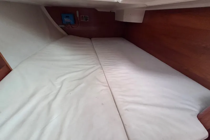Slide: The Image of Interior cabin of 1993 Beneteau Oceanis 400 sailboat with white bedding. - 22