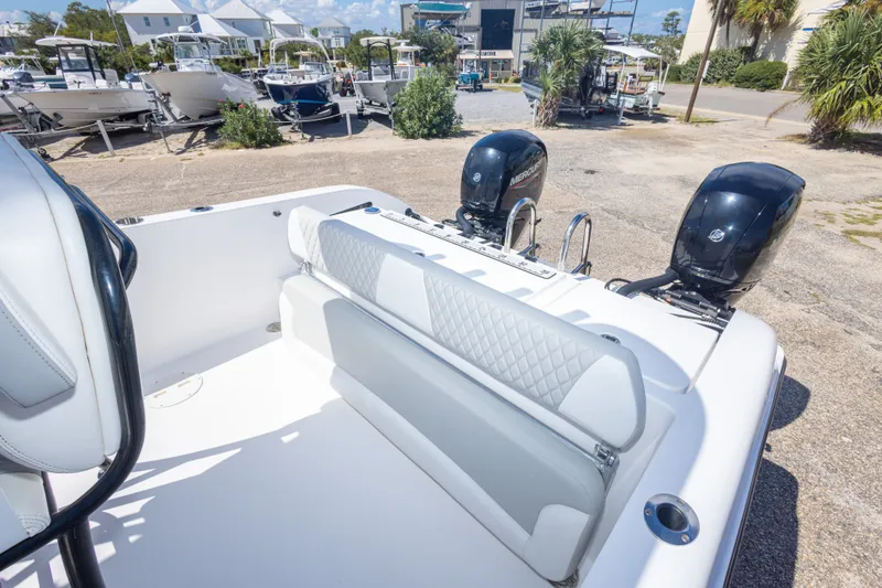 Slide: The Image of 2022 Twin Vee 240 GFX CC boat with dual Mercury engines at a marina. - 55