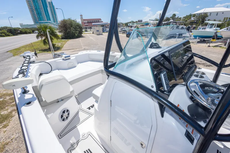 Slide: The Image of 2022 Twin Vee 240 GFX CC boat interior with modern console and seating. - 36