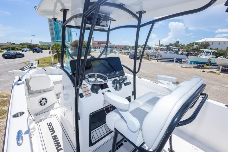 Slide: The Image of 2022 Twin Vee 240 GFX CC boat interior with steering console and seating. - 30