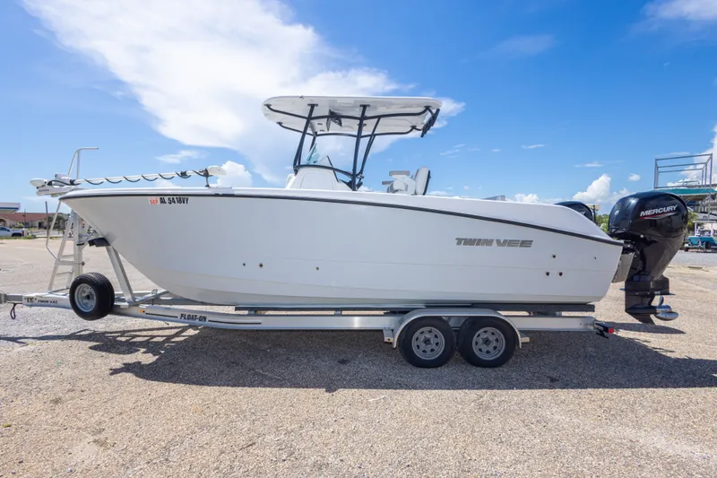 Slide: The Image of 2022 Twin Vee 240 GFX CC boat on trailer under clear blue sky. - 22
