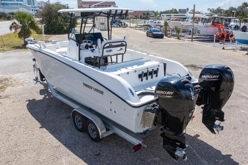 Slide: The Image of 2022 Twin Vee 240 GFX CC boat with dual Mercury engines on a trailer. - 18