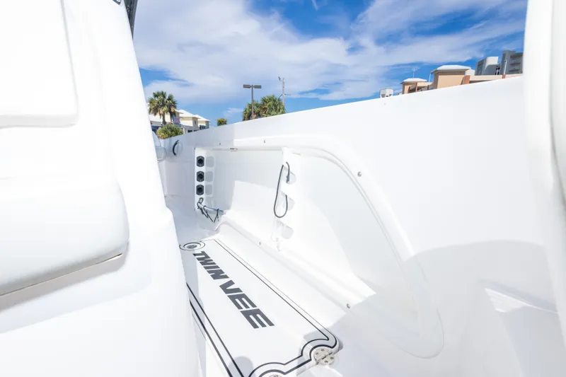 Slide: The Image of 2022 Twin Vee 240 GFX CC boat interior, showcasing sleek white design and branding. - 47