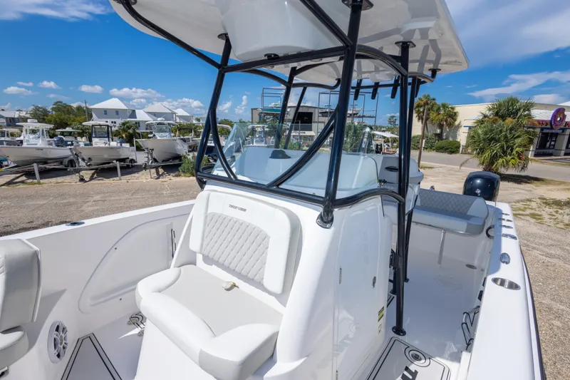 Slide: The Image of 2022 Twin Vee 240 GFX CC boat with sleek design, docked outdoors under blue sky. - 50