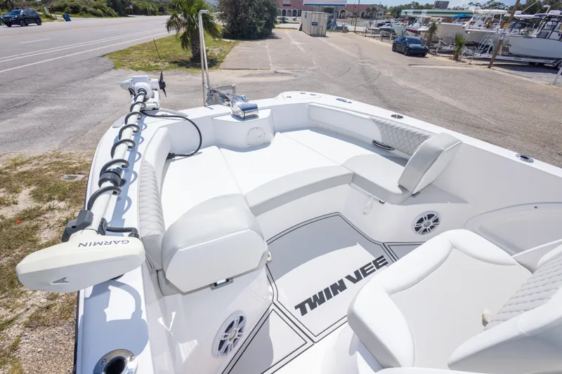 Slide: The Image of 2022 Twin Vee 240 GFX CC boat interior with Garmin equipment, parked near a road. - 38