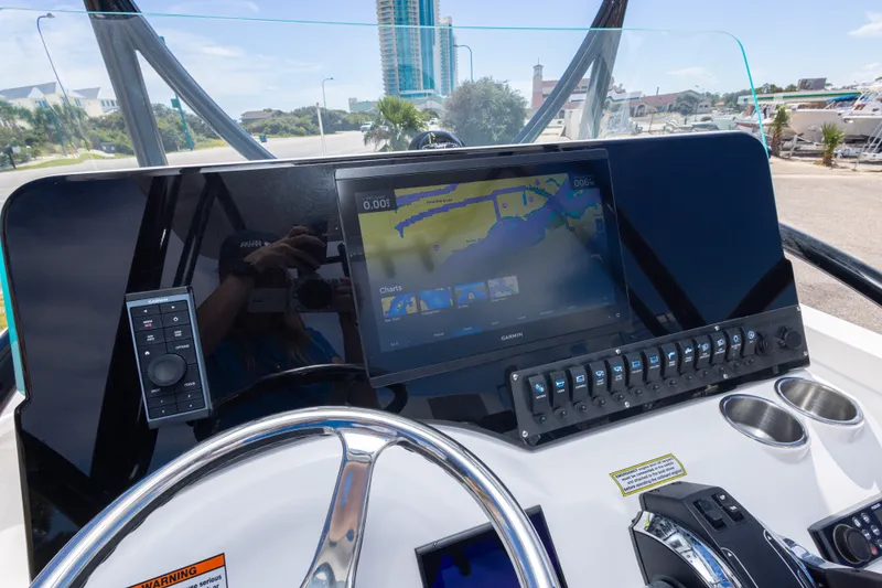 Slide: The Image of 2022 Twin Vee 240 GFX CC dashboard with Garmin navigation display and control panel. - 34