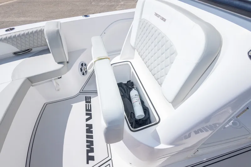 Slide: The Image of 2022 Twin Vee 240 GFX CC boat interior with storage compartment and seating. - 44