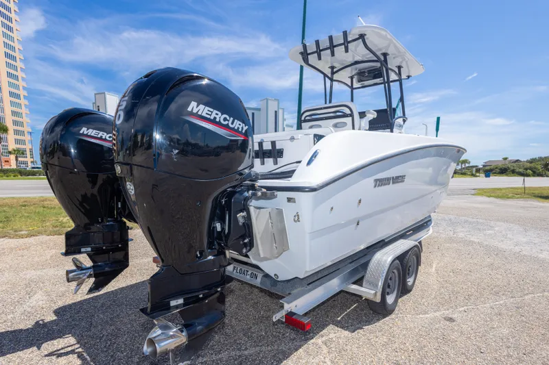 Slide: The Image of 2022 Twin Vee 240 GFX CC boat with dual Mercury engines on a trailer. - 19