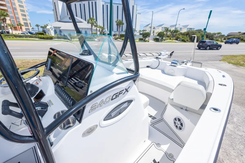 Slide: The Image of 2022 Twin Vee 240 GFX CC boat interior with modern dashboard and seating. - 35