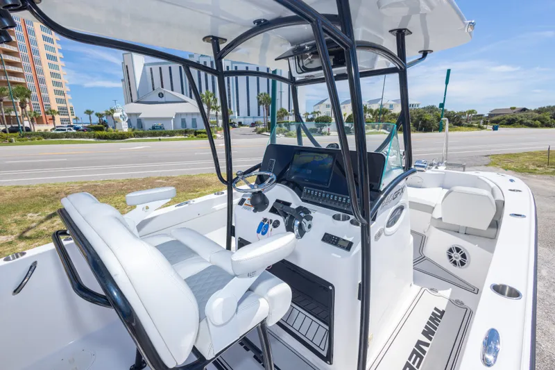 Slide: The Image of 2022 Twin Vee 240 GFX CC boat interior with modern helm and seating. - 29