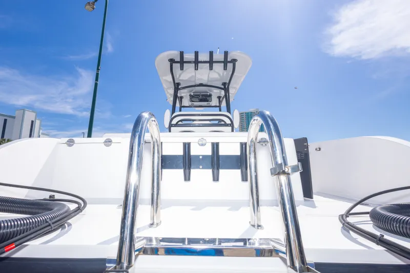 Slide: The Image of 2022 Twin Vee 240 GFX CC boat, rear view, under clear blue sky. - 61
