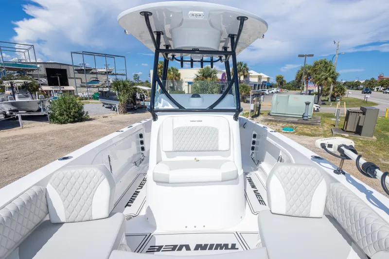 Slide: The Image of 2022 Twin Vee 240 GFX CC boat interior with white seating and open deck. - 43