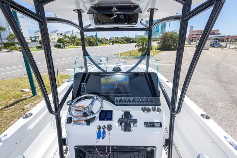 Slide: The Image of 2022 Twin Vee 240 GFX CC boat console with steering wheel and navigation display. - 31